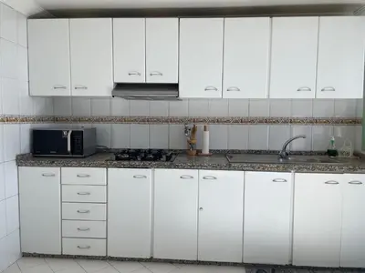 a white kitchen with white cabinets and a sink at ☆HIVERNAGE☆ Charming , Spacious & Bright with Pool in Marrakech