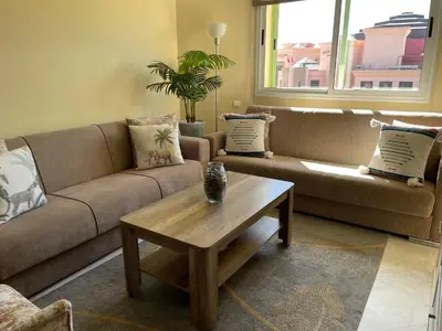 a living room with a couch and a coffee table at ☆HIVERNAGE☆ Charming , Spacious & Bright with Pool in Marrakech