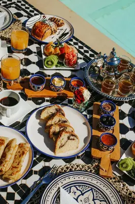 a table with plates of food on a checkered table cloth at L'Orientale By La Siredrah in Marrakech