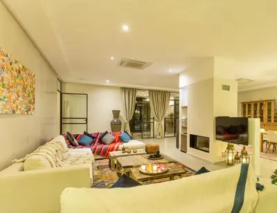 a living room with a couch and a tv at L'Orientale By La Siredrah in Marrakech