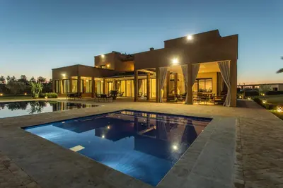 a house with a swimming pool in front of it at L'Orientale By La Siredrah in Marrakech