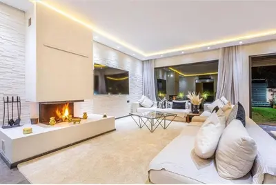 a living room with a fireplace and a couch at Splendide Villa Lilya in Marrakech