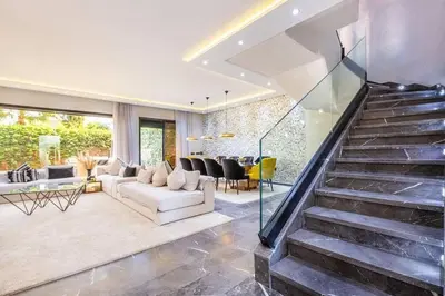 a living room with a staircase and a couch at Splendide Villa Lilya in Marrakech