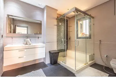 a bathroom with a glass shower and a sink at Splendide Villa Lilya in Marrakech