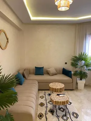 a living room with a couch and two tables at Luxury & cosy apartment in Marrakech