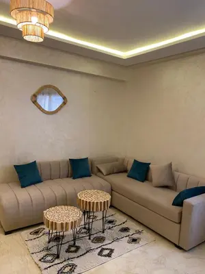 a living room with two couches and two tables at Luxury & cosy apartment in Marrakech
