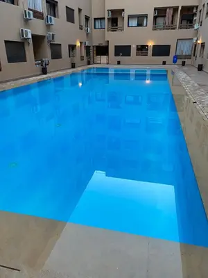 a large blue swimming pool in a building at Luxury & cosy apartment in Marrakech