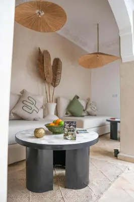 a table with a bowl of fruit on it in a living room at Riad Chic in Marrakech