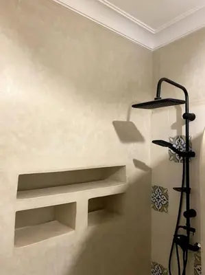 a room with a shelf in the corner of a wall at Riad Chic in Marrakech