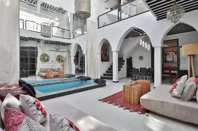 a living room with a pool in the middle at Riad Modern Bed & Breakfast - Top location in Marrakech