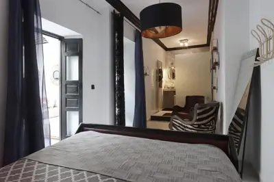 a bedroom with a bed and a mirror at Riad Modern Bed & Breakfast - Top location in Marrakech