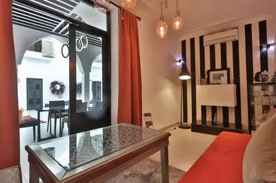 a living room with a glass table and a dining room at Riad Modern Bed & Breakfast - Top location in Marrakech