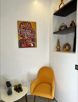 a living room with a chair and a table at Riad Manzal in Marrakech
