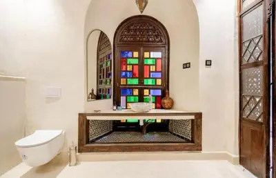 a bathroom with a toilet and a stained glass window at Riad Manzal in Marrakech