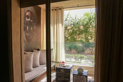 a room with a bed and a large window at Dar Lala Mama in Marrakech
