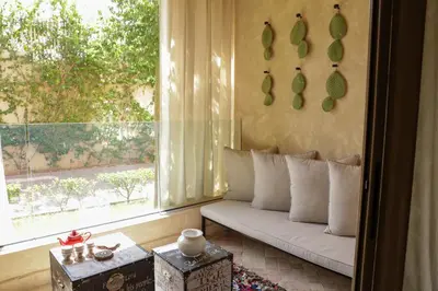 a living room with a couch and a window at Dar Lala Mama in Marrakech