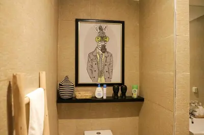 a bathroom with a picture of a man wearing sunglasses at Dar Lala Mama in Marrakech