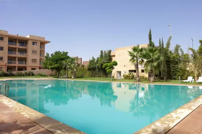 a large swimming pool in front of a building at Dar Lala Mama in Marrakech