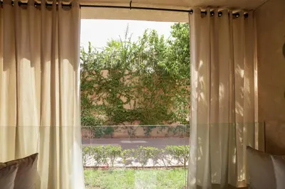 a window with a view of a yard at Dar Lala Mama in Marrakech