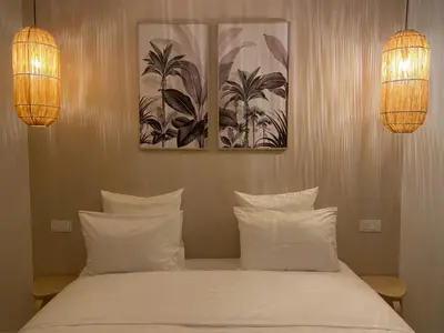 a bedroom with two lights and a bed with white pillows at Riad Coconut in Marrakech