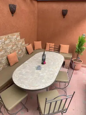a table and chairs in a room with a table and chairs at Riad Le Roy’s in Marrakech