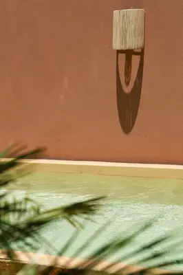 a wall with a painting of a face on it at Riad Pompon in Marrakech