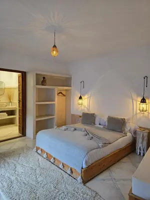 a bedroom with a large bed in a room at RIAD SAMAH in Marrakech