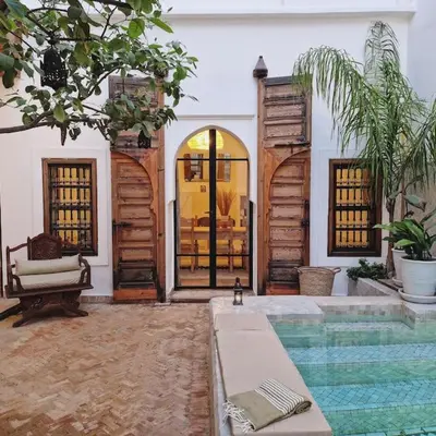 a house with a swimming pool next to a house at RIAD SAMAH in Marrakech