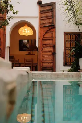 a swimming pool in front of a house at RIAD SAMAH in Marrakech
