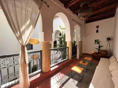 a living room with a balcony with a couch at Riad l'Echappée, en exclusivité, 5 chambres in Marrakech
