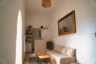 a living room with a couch and a mirror at Riad l'Echappée, en exclusivité, 5 chambres in Marrakech
