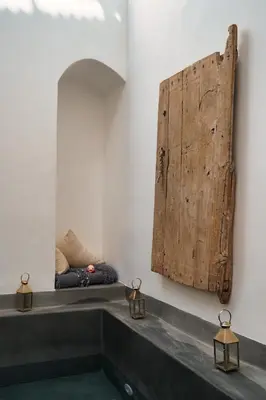 a bathroom with a large wooden door on the wall at Riad l'Echappée, en exclusivité, 5 chambres in Marrakech