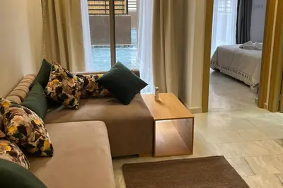 a living room with a couch and a table at 1Bed Apartment - Sleeps 4 - Balcony Wifi Parking in Marrakech