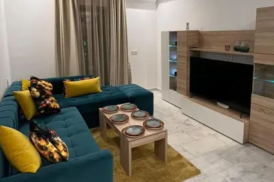 a living room with a blue couch and a tv at 1Bed Apartment - Sleeps 4 - Balcony Parking Wifi in Marrakech