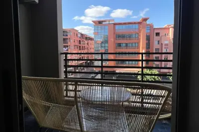 a bench on a balcony with a view of a building at 1Bed Apartment - Sleeps 4 - Balcony Parking Wifi in Marrakech
