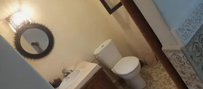 a bathroom with a toilet and a sink and a mirror at MAISON PROCHE DANS LA MEDINA MARRAKECH in Marrakech