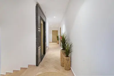 a hallway with stairs and a potted plant at Aya Suites in Marrakech