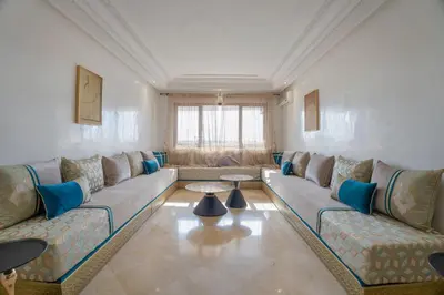 a large living room with a couch and a table at Aya Suites in Marrakech