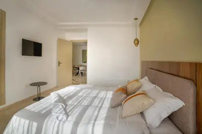 a bedroom with a bed with white sheets and pillows at Aya Suites in Marrakech