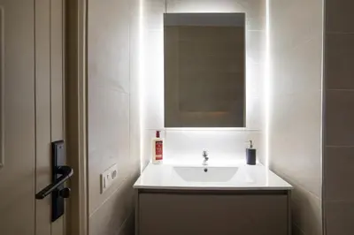 a bathroom with a white sink and a mirror at Aya Suites in Marrakech