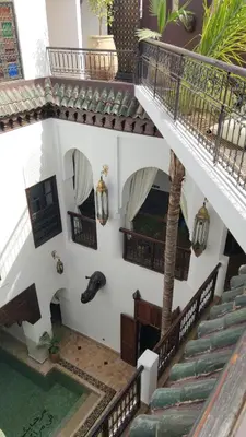 an overhead view of a building with stairs and a pool at Ryad Petit Palmier in Marrakech