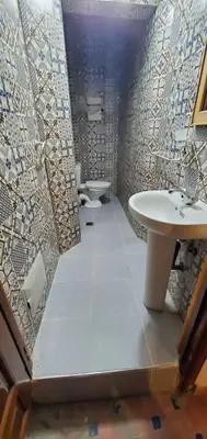 a bathroom with a sink and two toilets in it at Riad 1954 in Marrakech