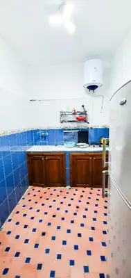 a kitchen with a blue and white tiled floor at Riad 1954 in Marrakech