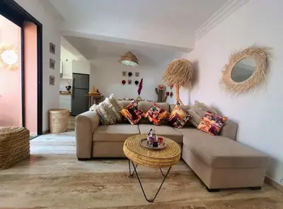 a living room with a couch and a table at Bel appartement au centre gueliz in Marrakech
