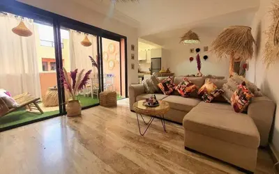 a living room with a couch and a table at Bel appartement au centre gueliz in Marrakech
