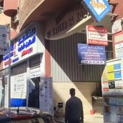 a man standing in front of a building with signs at Charmant appartement moderne au cœur de Gueliz, Marrakech Lumineux