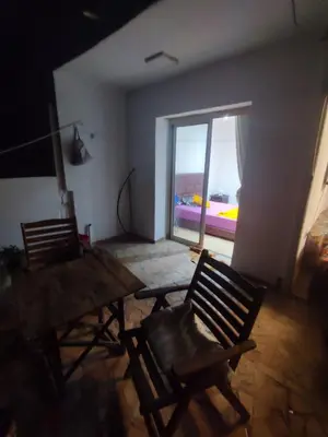 two chairs and a wooden table in a room with a window at Charmant appartement moderne au cœur de Gueliz, Marrakech Lumineux