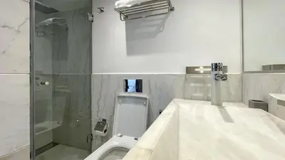 a bathroom with a toilet and a sink and a shower at Duplex IKA - Appartement design à Marrakech in Marrakech