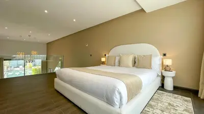 a bedroom with a large white bed and a window at Duplex IKA - Appartement design à Marrakech in Marrakech