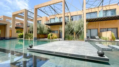 a swimming pool in front of a building at Duplex Zoé - Contemporain et design à Marrakech in Marrakech